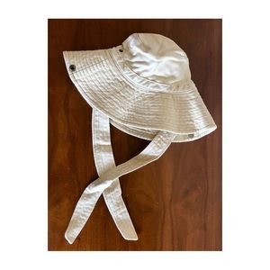 Cream, wide brimmed fisherman style bucket hat with straps
